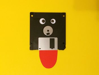 Anthropomorphic floppy disk against yellow background