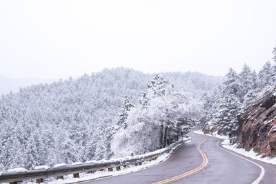 Snow covered road against sky