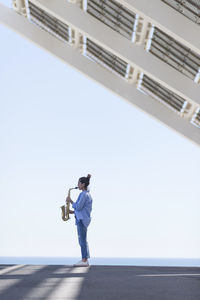 Full length of man standing on bridge against sky