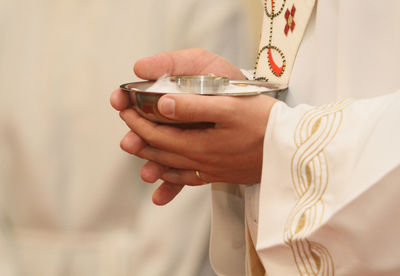 Midsection of man holding drink