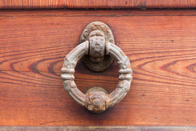 Close-up of door knocker on wood