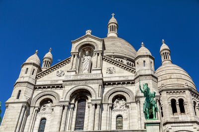 Low angle view of sacré coeur against blue sky