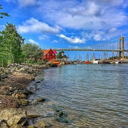 Bridge against cloudy sky