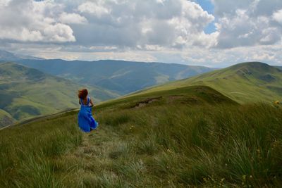 Full length of woman running in the moutains 