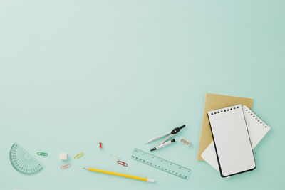 Close-up of colored pencils on table against white background
