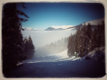 Scenic view of snow covered mountains against sky