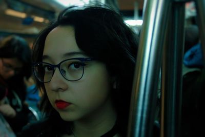 Close-up portrait of young woman in train