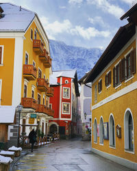 Colourful residential buildings by town against sky in hallstatt austria 