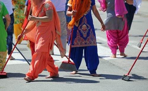 Low section of people walking on street