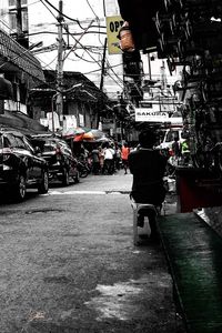 Man on car in city