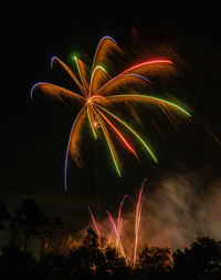 Low angle view of firework display at night