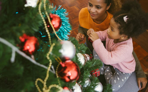 High angle view of girl and christmas tree