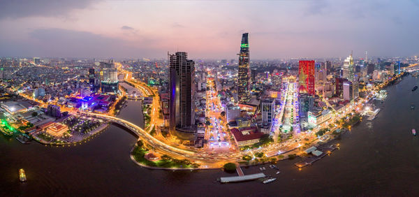 High angle view of city lit up at night