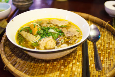 High angle view of fresh pho served in wicker tray