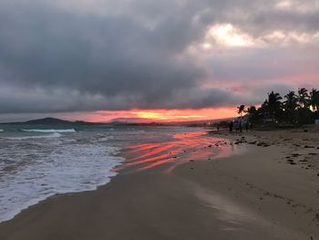 Scenic view of beach against sky during sunset