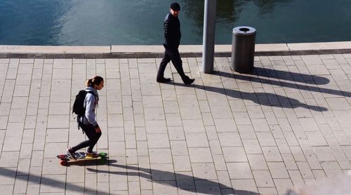 High angle view of people walking on footpath