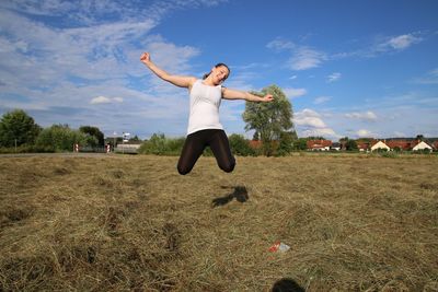 Full length of man jumping in mid-air against sky