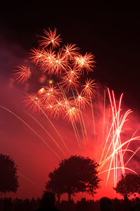 Low angle view of firework display at night