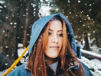 Woman looking away during snowfall