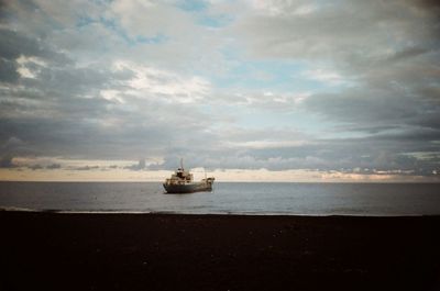 Scenic view of sea against cloudy sky