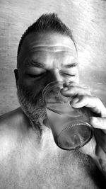 Close-up portrait of a young man drinking water