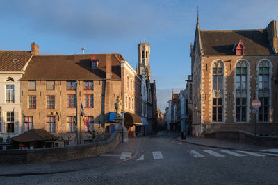 Street amidst buildings in town against sky