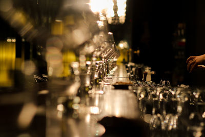 Wineglasses arranged on counter at bar