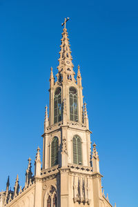 Low angle view of building against clear blue sky