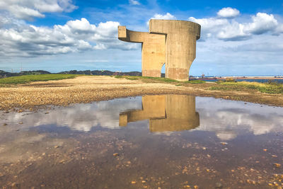 Sculpture reflected on a puddle. elogio del horizonte by eduardo chillida