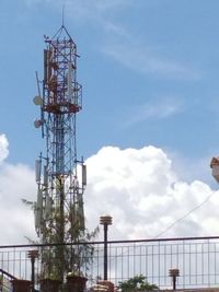 Low angle view of communications tower against sky