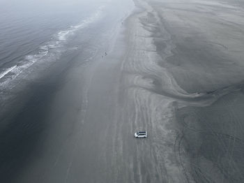 High angle view of cars on road by sea