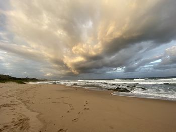 Scenic view of beach against sky during sunset