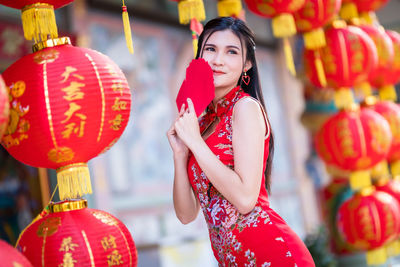 Portrait of smiling young woman standing outdoors