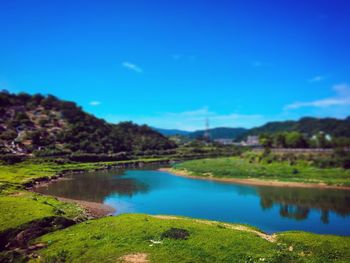 Scenic view of lake against blue sky