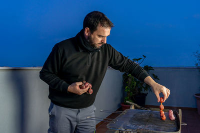 Man preparing food on barbecue