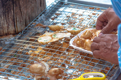 High angle view of person preparing food in cage