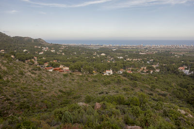 High angle view of houses by sea against sky