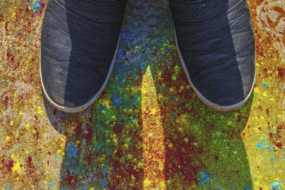 Low section of person standing on messy field during autumn
