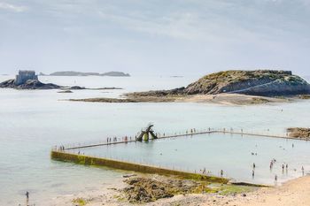 High angle view of swimming pool by sea against sky
