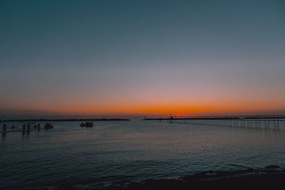 Scenic view of sea against clear sky during sunset