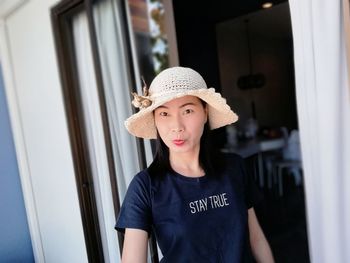 Close-up of young woman wearing hat