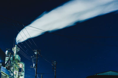 Low angle view of illuminated electricity pylon at night