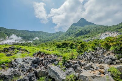 Scenic view of mountains against cloudy sky