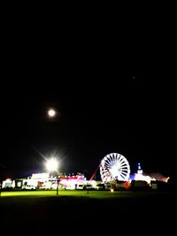 Illuminated ferris wheel at night