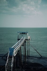 Pier over sea against sky