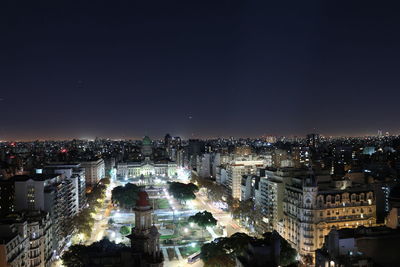 Illuminated cityscape against sky at night