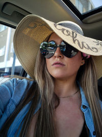 Portrait of young woman wearing hat