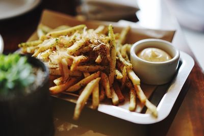 Close-up of french fries with sauce