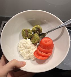 Cropped hand holding food in plate