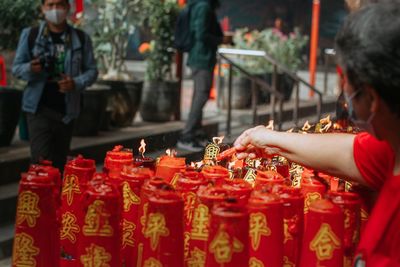 Side view of woman holding candle 